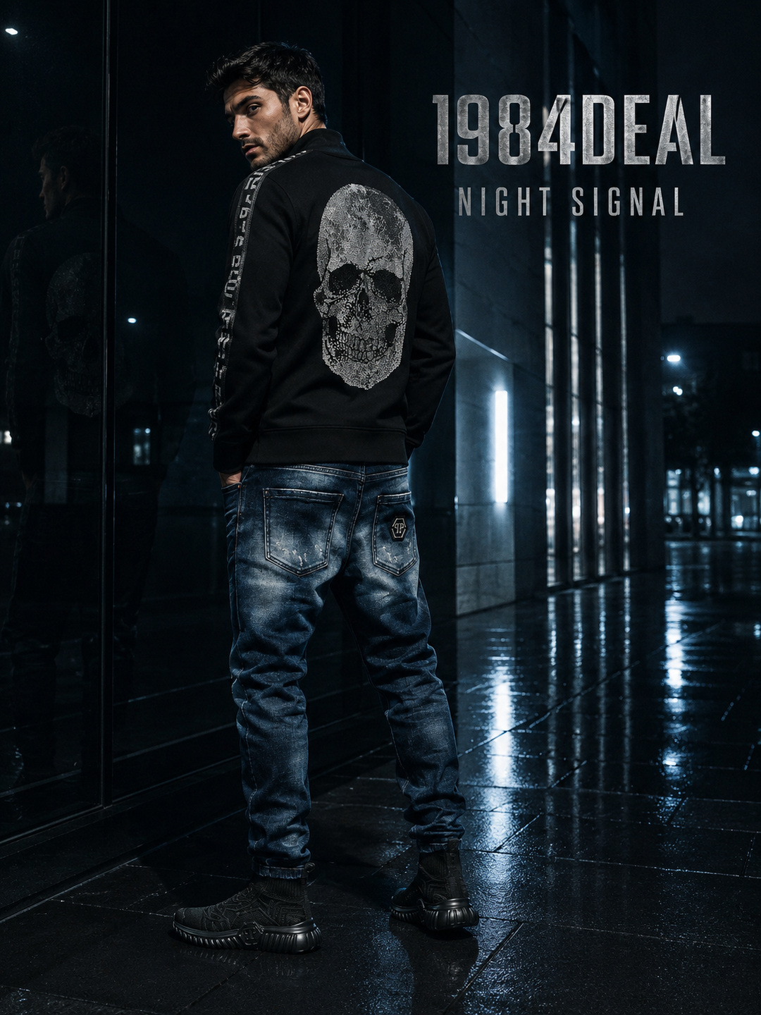 Man wearing a black skull sweatshirt, dark-blue jeans and black high-top sneakers at night