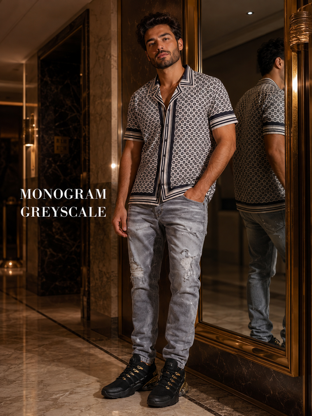 Men's monochrome outfit with a patterned shirt, gray jeans and black-gold sneakers.