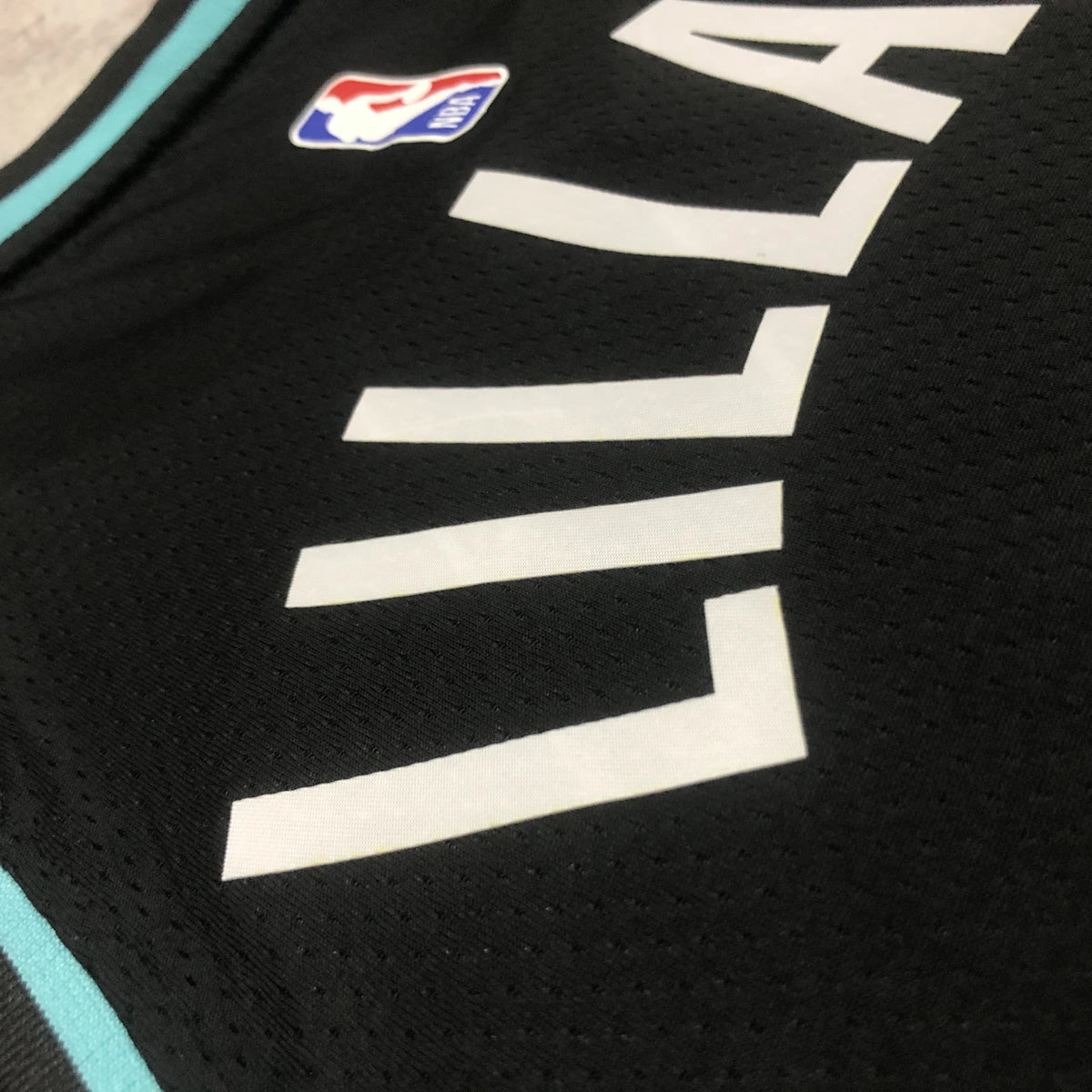 Portland Trail Blazers 2025-26 city edition basketball jersey close-up of sleeve and armhole stitching in team colors for basketball fans
