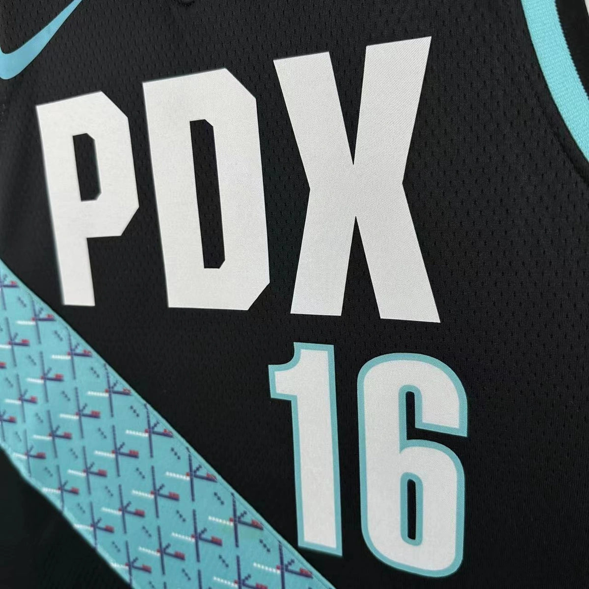 Portland Trail Blazers 2025-26 home basketball jersey close-up of jock tag and hem details in team colors for basketball fans