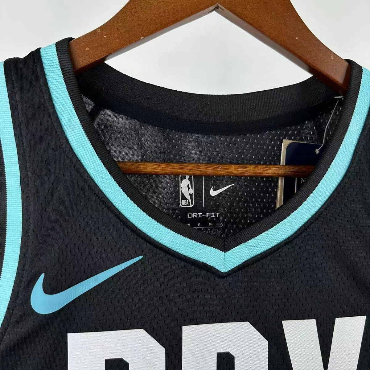 Portland Trail Blazers 2025-26 home basketball jersey close-up of collar and neckline stitching in team colors for basketball fans